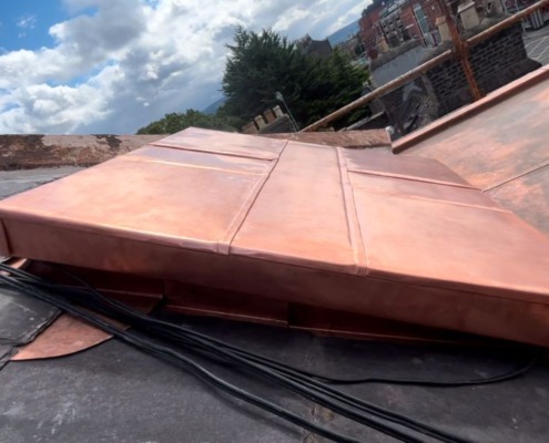 Copper ridge capping on a slate roof